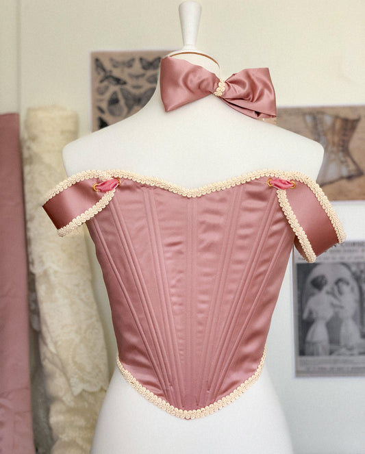 Pink corset with off-shoulder sleeves